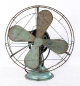A circa 1940s green GEC caged oscillating fan,