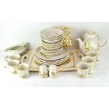 An extensive Harvest pattern 1418 tea and dinner service, including tea cups, tea pot,