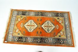 A Turkish wool runner of blue, beige and rust-coloured pattern,