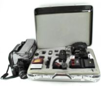A collection of cameras and lenses, including a Cobra 700AF, Canon Ultrasonic EOS 100 camera