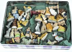 A collection of Wade Whimsies in assorted colours and designs, including figures,