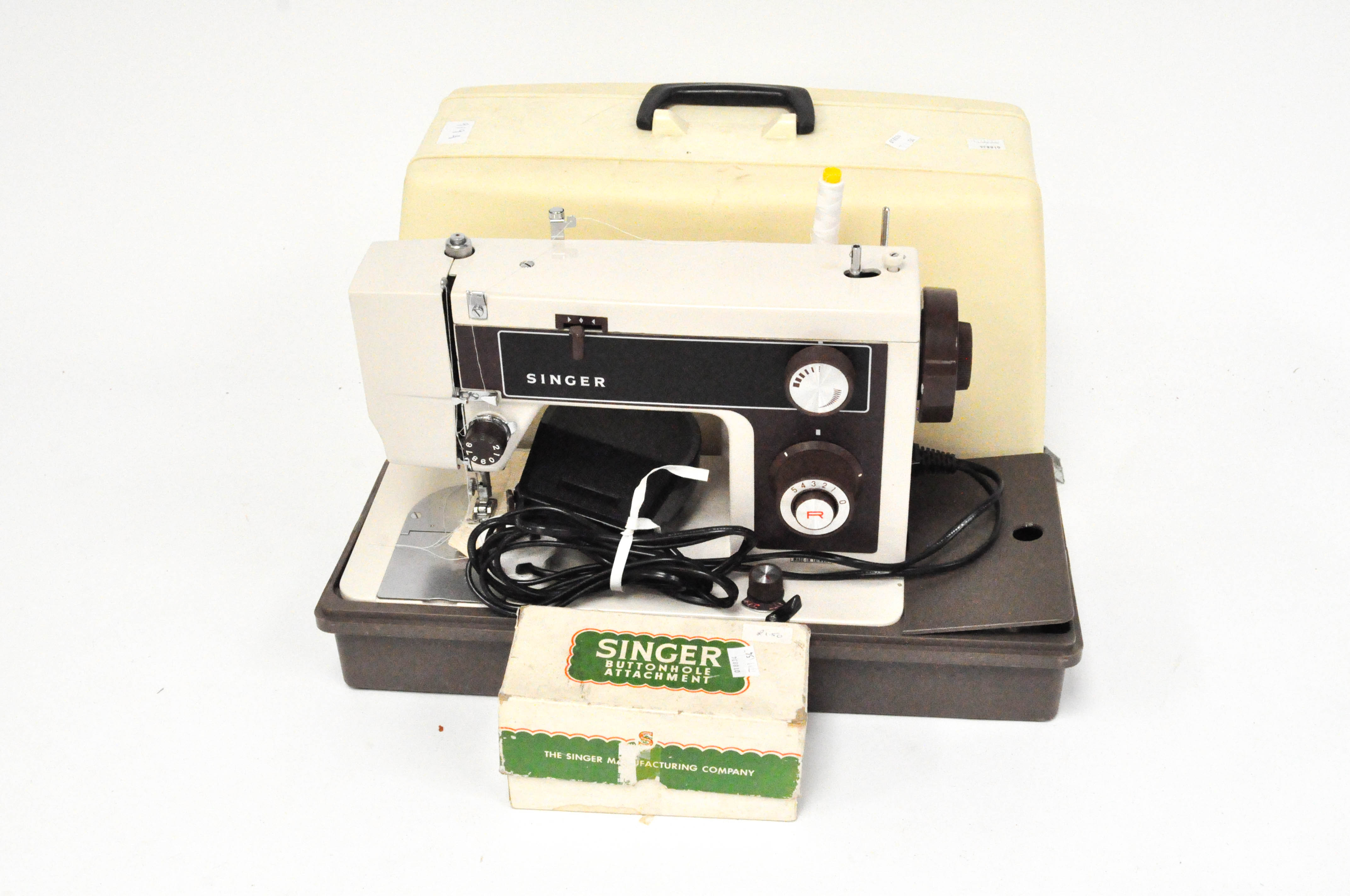 A vintage Singer electric sewing machine, in plastic case,