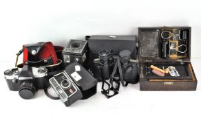 A collection of vintage cameras, including a Kodak Six-20 'Brownie' C, Kodak 304 and a Pentaflex SL,