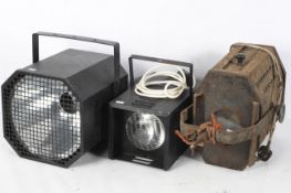 Three large vintage spotlights, one of rectangular and two of octagonal form,