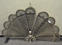 A late 19th/early 20th century brass peacock/griffin fire screen with expanding tail screen, 62.