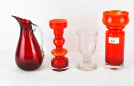 A red glass water pouring jug together with two retro coloured glass vases and a goblet