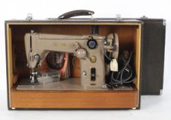 A Singer Automatic sewing machine, model 306K, with case and instructions