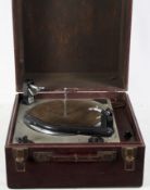 A vintage Collaro microgram tabletop record player, within a leatherette carry case,