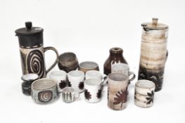 A collection of Briglin studio pottery including two large coffee pots, mugs and vessels,
