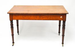 A 20th Century wooden table, with curved corners, supported on turned legs with wheels to the bases,
