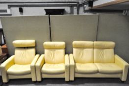 A banana yellow reclining Stressless two seat sofa and two matching chairs,