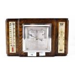 An Art Deco wall hanging oak cased barometer, flanked by a thermometer and storm glass,