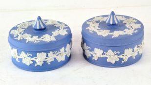 A pair of Wedgwood Jasperware blue and white pots and covers, circular in form,
