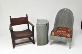 A low armchair, the seat and back of leather with a Lloyd Loom nursing chair and a laundry basket