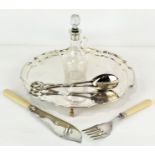 A silver topped jug with a silver rimmed knife and fork and silver plated pair of tongs and platter