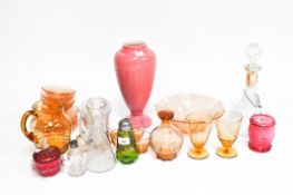 A collection of assorted vintage glassware, including a pink vase with enamel flowers, a decanter,
