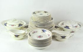 A Portland pottery Cobridge part dinner service gilt and decorated with scrollwork and flowers