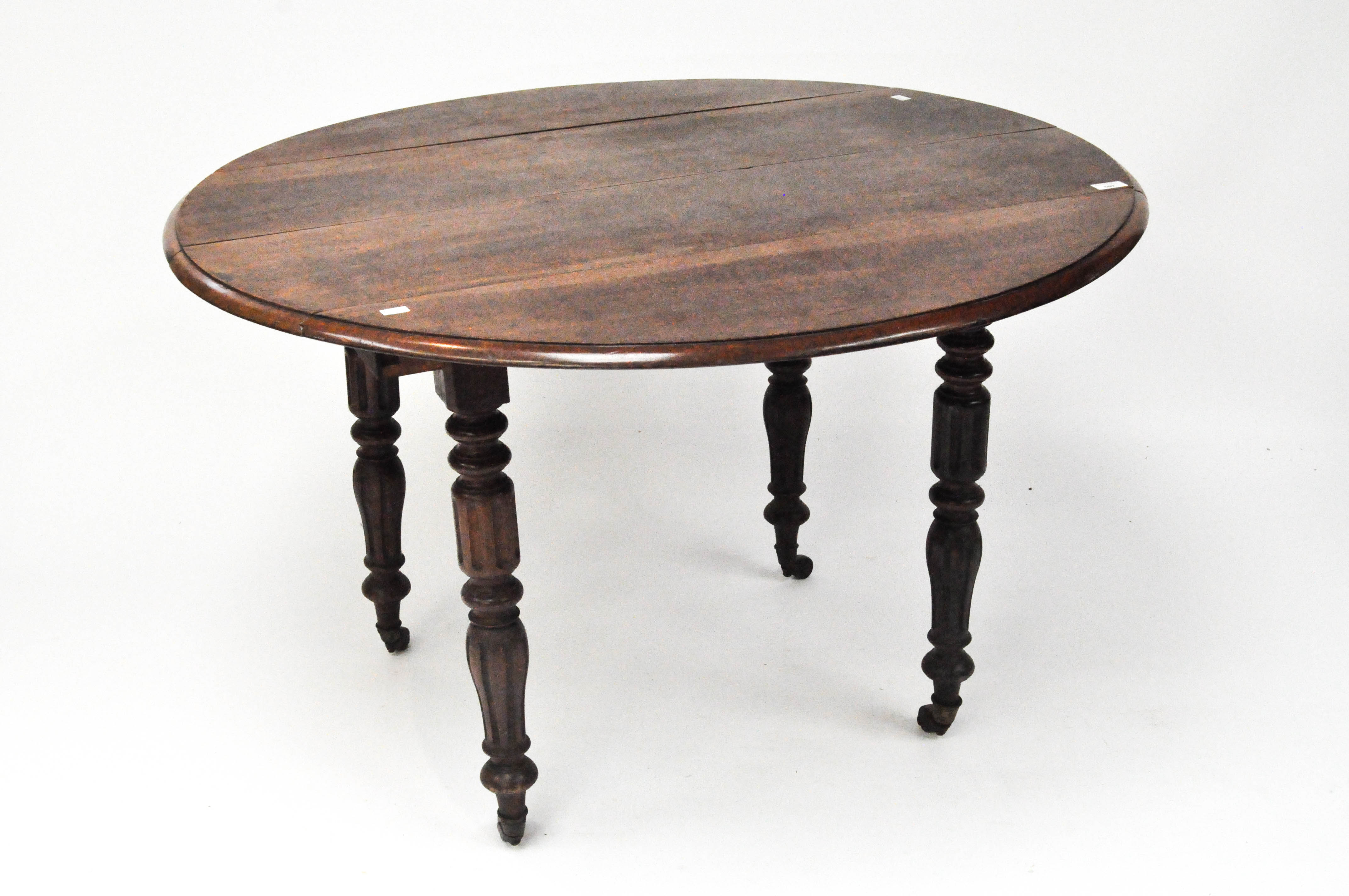 A large late 19th-early 20th Century manhogany drop leaf table, of circular shape,