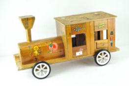 A vintage homemade wooden 'sit-on' train, with hinged doors and decorated with flowers and animals,