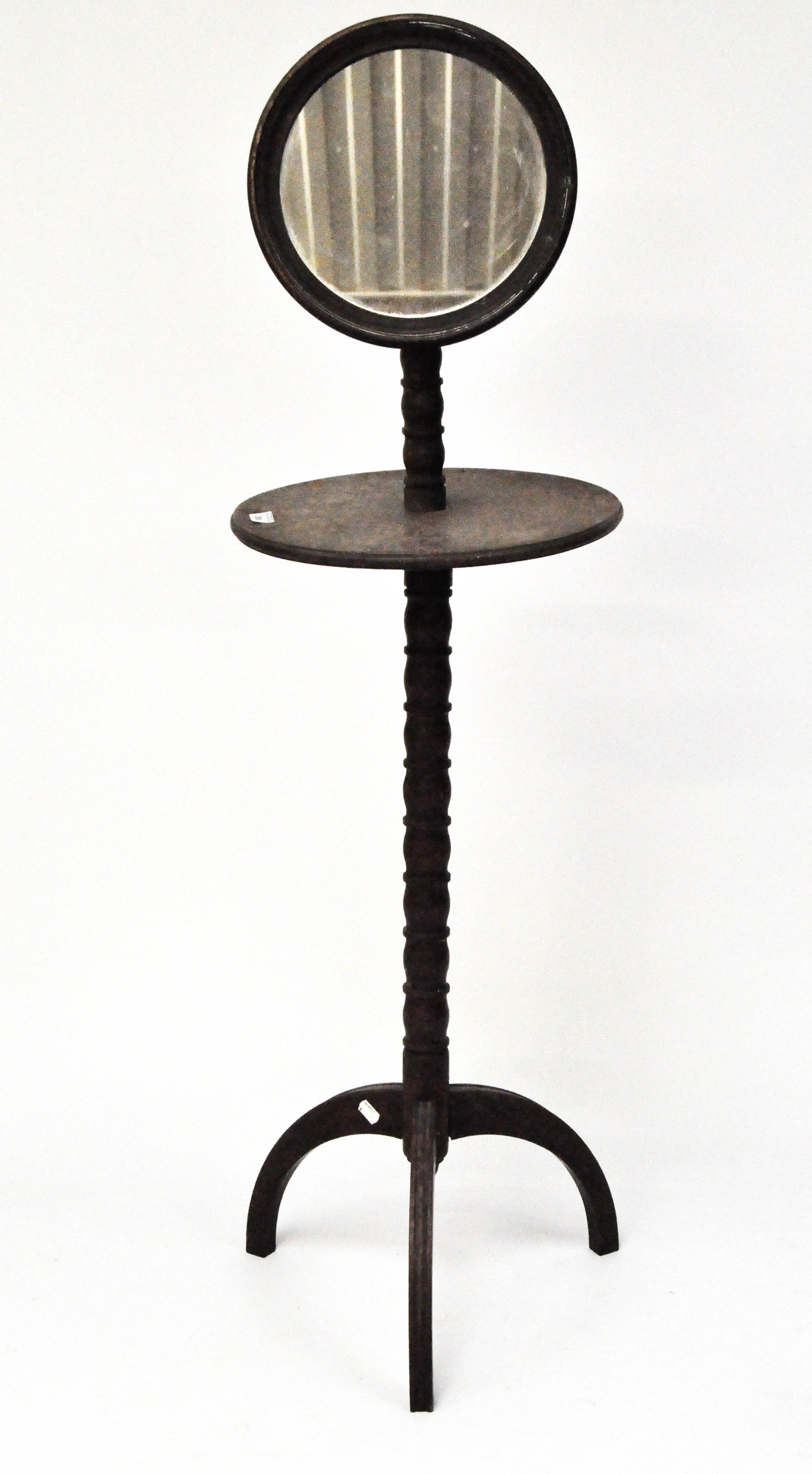 A late 19th century mahogany shaving stand, with adjustable mirror to top above a circular shelf,