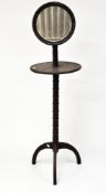 A late 19th century mahogany shaving stand, with adjustable mirror to top above a circular shelf,
