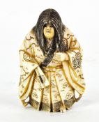 A Japanese ivory netsuke, modelled as a gentleman in traditional attire, with moving face,