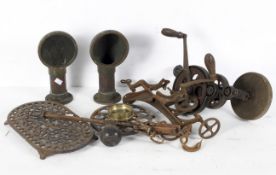 A quantity of vintage brass and ironware including a large hand drill, clamp, trivets, chimneys,