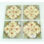 A set of four Victorian fire place tiles, printed with floral decoration on a cream ground,