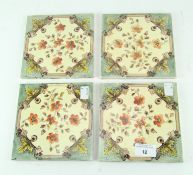 A set of four Victorian fire place tiles, printed with floral decoration on a cream ground,