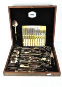 A vintage canteen of gilt finished cutlery together with a set of chrome plated fish cutlery