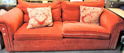 A modern four seater sofa upholstered in rust-red velour, width circa 240cm,