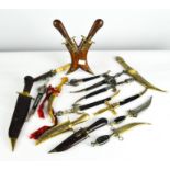 A collection of assorted dress knives, most of Middle Eastern designs,