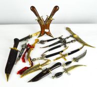 A collection of assorted dress knives, most of Middle Eastern designs,