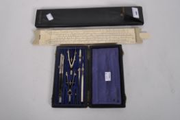 A Thornton sliding rule in fitted leather case with a drawing set with various instruments