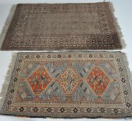 Two wool rugs, the first with orange and pale blue lozenges within geometric border,