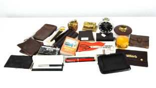 A selection of pens and leather cigar cases, together with metal bangles and more