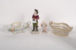 A German porcelain figure of a beau with two Dresden style bowls and a figure of a woman