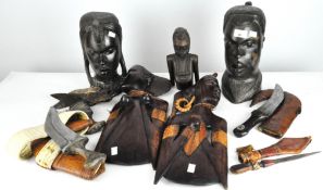 A parcel of African wooden tribal carvings, together with a selection of knives