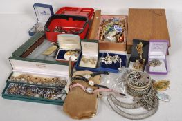 A large quantity of costume jewellery, assorted necklaces, brooches, medals and wrist watches,