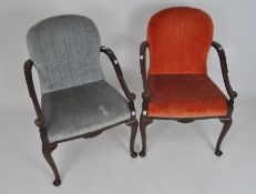 A pair of oak upholstered elbow chairs, upholstered in pale blue and red velvet,