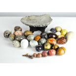A collection of assorted vintage stone eggs, various designs and materials,