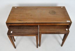 A teak nest of three tables, circa 1960, comprising: a rectangular table and two smaller,