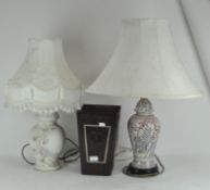Two lamps and a leather bin, the lamps printed or moulded with flowers, with cream coloured shade,