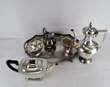 A silver plated tray together with a tea set and coffee pot,