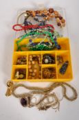 A box of vintage costume jewellery including necklaces, brooches and other items,