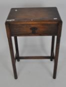 A early 20th century oak side table, with a single drawer, on octagonal supports