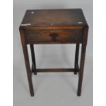 A early 20th century oak side table, with a single drawer, on octagonal supports