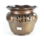 An early 20th century Art Nouveau copper jardiniere, adorned with pierced and embossed detailing,
