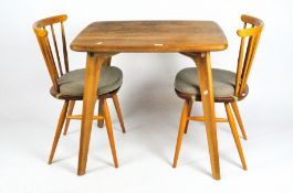 A pair of spindle back beech Ercol chairs together with a modern Ercol-style table
