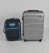 Two contemporary suitcases, both with wheels and handles, one by Everest, the other by Skyflite,